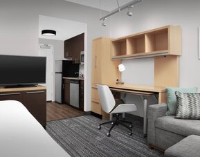 Day room amenities include TV, work desk, sofa, and in-room kitchen at TownePlace Suites Franklin Cool Springs.