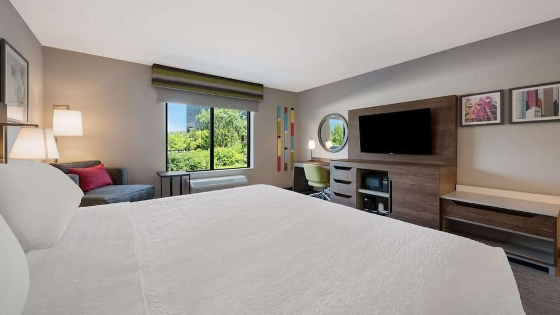 Day use room with work desk and sofa at Hampton Inn Detroit Southfield.
