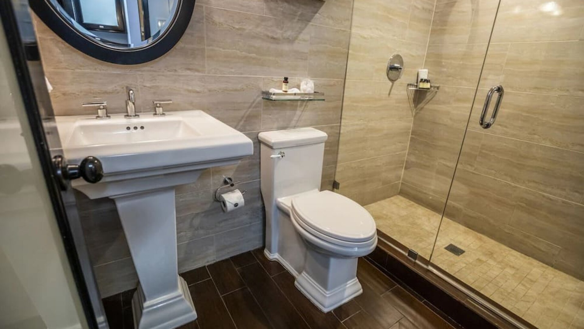 Private guest bathroom with shower and free toiletries at Hotel Croydon.