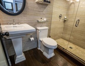 Private guest bathroom with shower and free toiletries at Hotel Croydon.