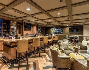 Dining area with lounge seating at Hilton Baton Rouge Capitol Center.