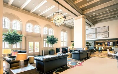 Hotel lobby with comfortable seating and workspace, perfect for coworking at Hilton Baton Rouge Capitol Center.