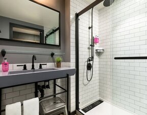 Private guest bathroom with shower at Moxy Boston Downtown.