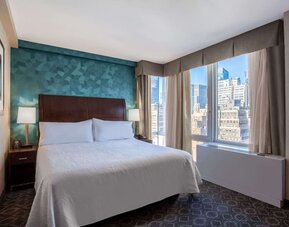 King bedroom with city views at Hilton Garden Inn New York/West 35th Street.
