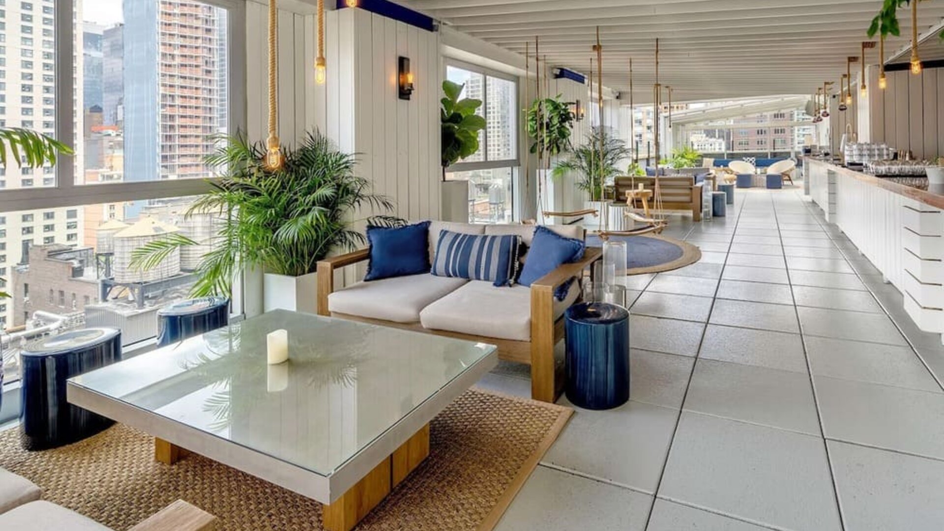 Rooftop bar and dining area with natural light at Hilton New York Fashion District.