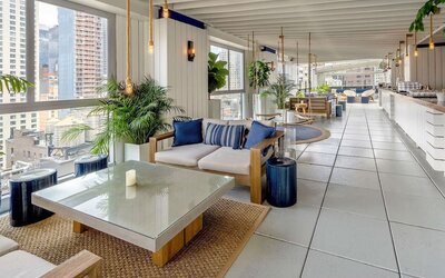 Rooftop bar and dining area with natural light at Hilton New York Fashion District.