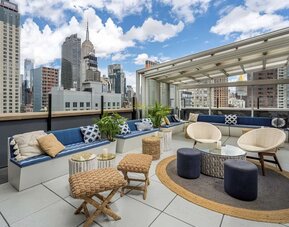 Rooftop coworking space with a view of the city at Hilton New York Fashion District.