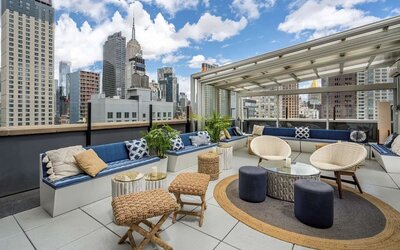 Rooftop coworking space with a view of the city at Hilton New York Fashion District.