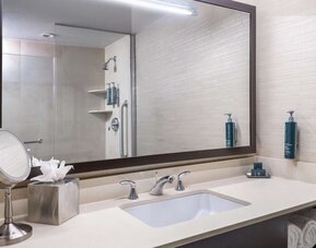 Guest bathroom with shower at Hilton New York Fashion District.