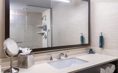 Guest bathroom with shower at Hilton New York Fashion District.