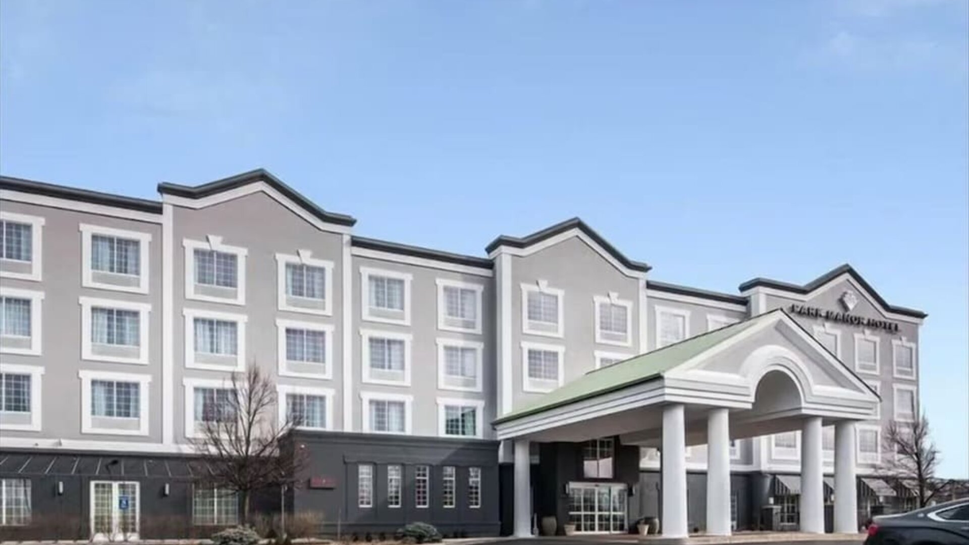 Exterior and parking area at Park Manor Hotel.