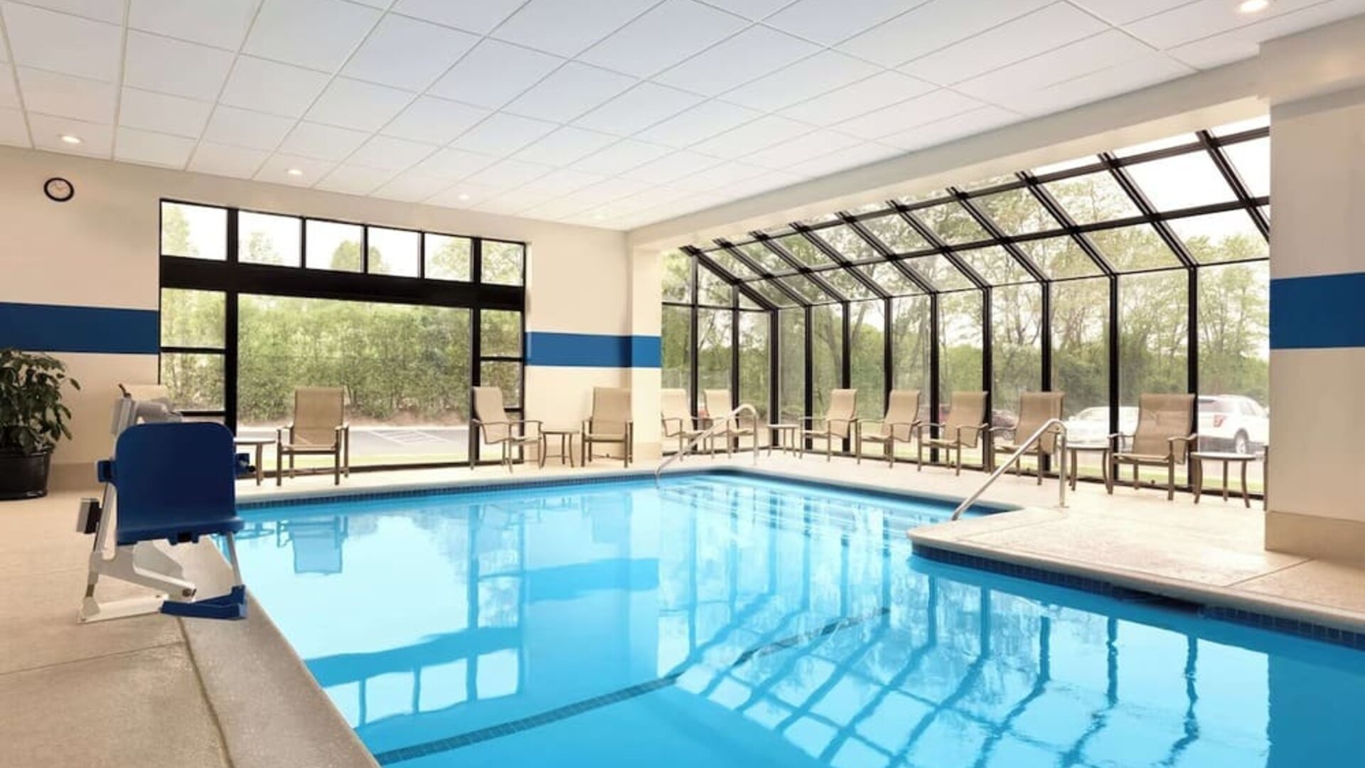 Indoor pool with lounge chairs at DoubleTree By Hilton Hartford - Bradley Airport.