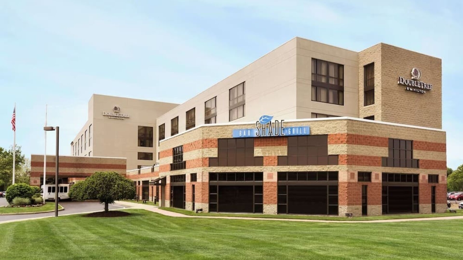 Hotel exterior and parking area at DoubleTree By Hilton Hartford - Bradley Airport.