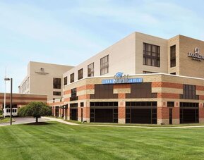 Hotel exterior and parking area at DoubleTree By Hilton Hartford - Bradley Airport.