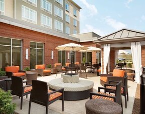 Courtyard with plenty of chairs perfect for coworking at Hilton Garden Inn Boston Logan Airport.