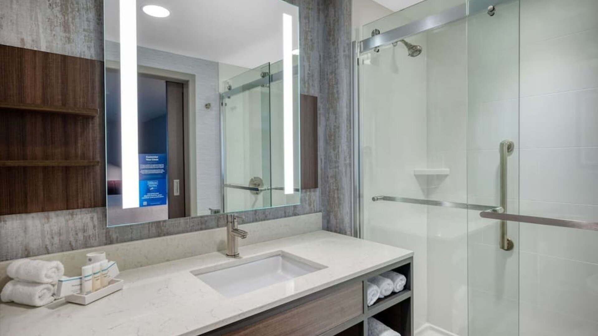 Private guest bathroom with shower at Hilton Garden Inn Boston Logan Airport.