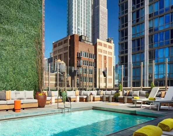 Stunning outdoor pool surrounded by skyscrapers at Royalton Park Avenue.