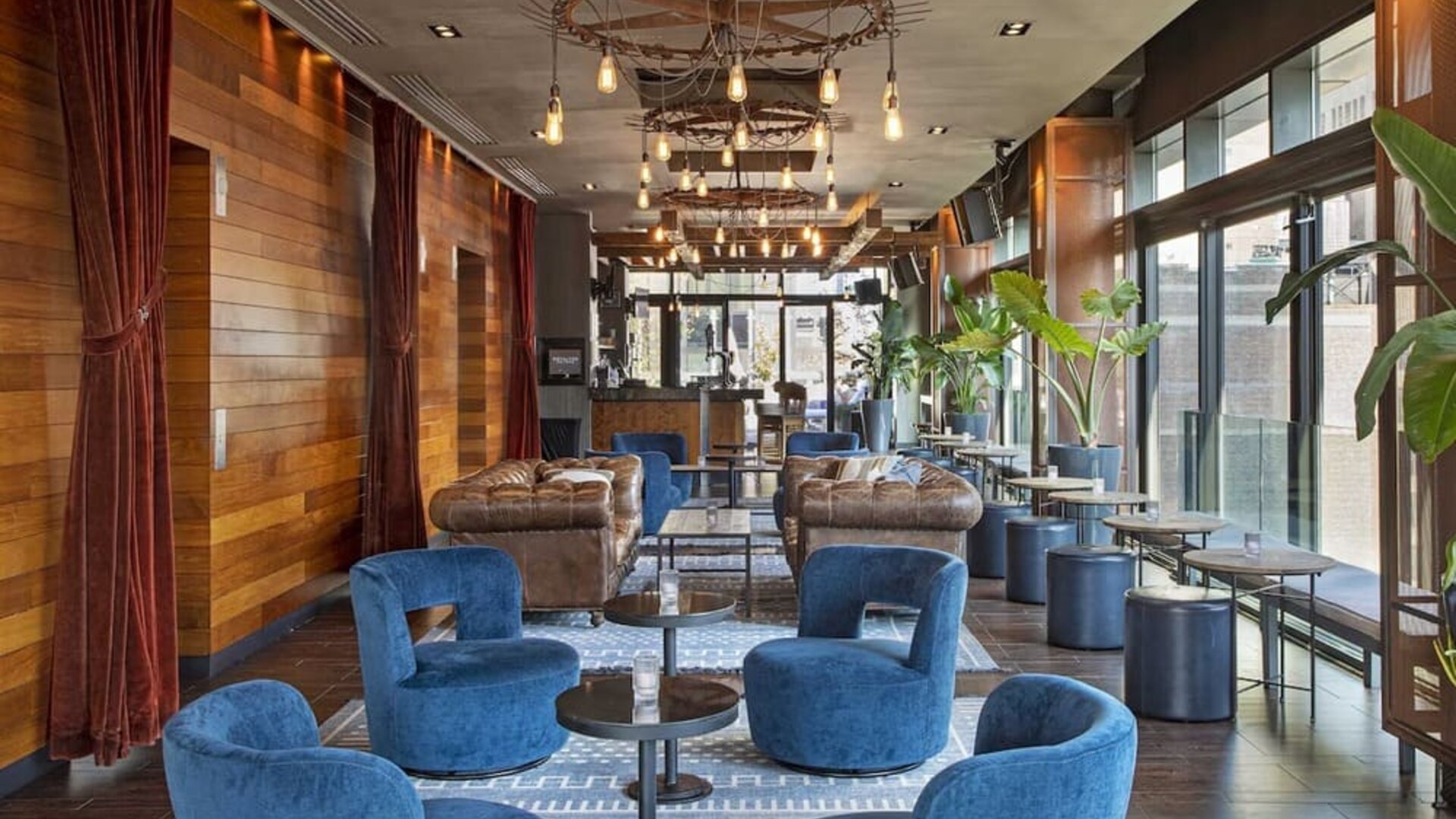 Lounge and coworking area beside elevators at Royalton Park Avenue.
