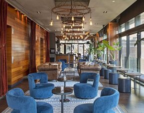 Lounge and coworking area beside elevators at Royalton Park Avenue.
