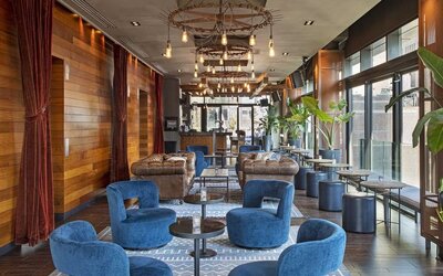 Lounge and coworking area beside elevators at Royalton Park Avenue.
