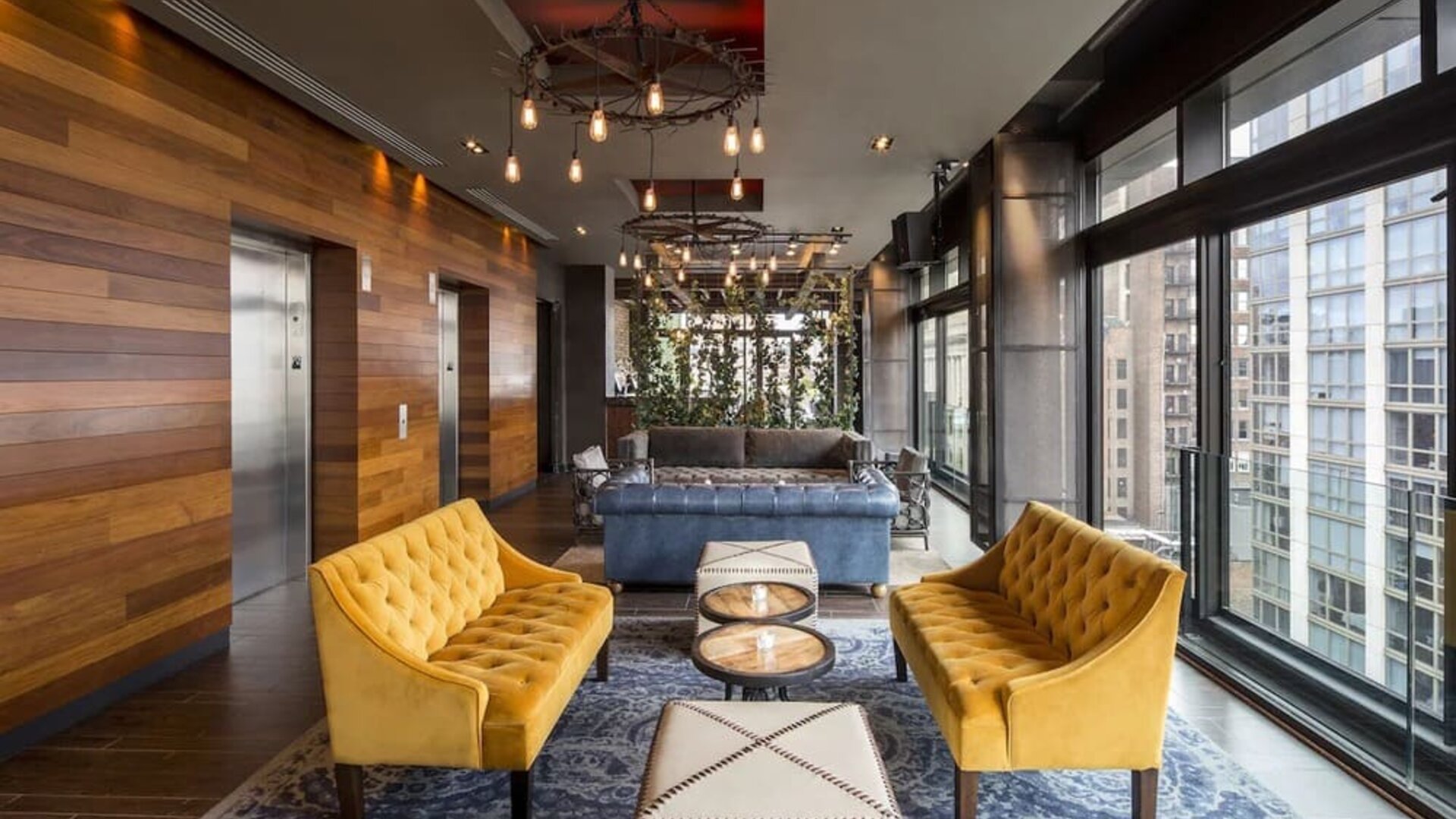 Lounge and coworking area beside elevators at Royalton Park Avenue.