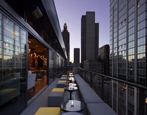 Hotel bar with balcony at Royalton Park Avenue.