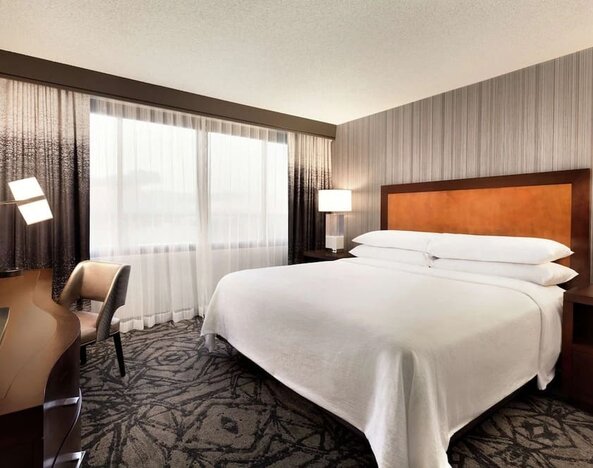 Delux king room with TV and work desk at Embassy Suites By Hilton Santa Clara Silicon Valley.