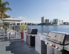 Grill and picnic area with a great view of the lagoon at Homewood Suites By Hilton Miami Airport-Blue Lagoon.