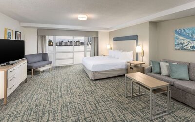 Spacious day use room with sofa and a view of the Blue Lagoon at Homewood Suites By Hilton Miami Airport-Blue Lagoon.
