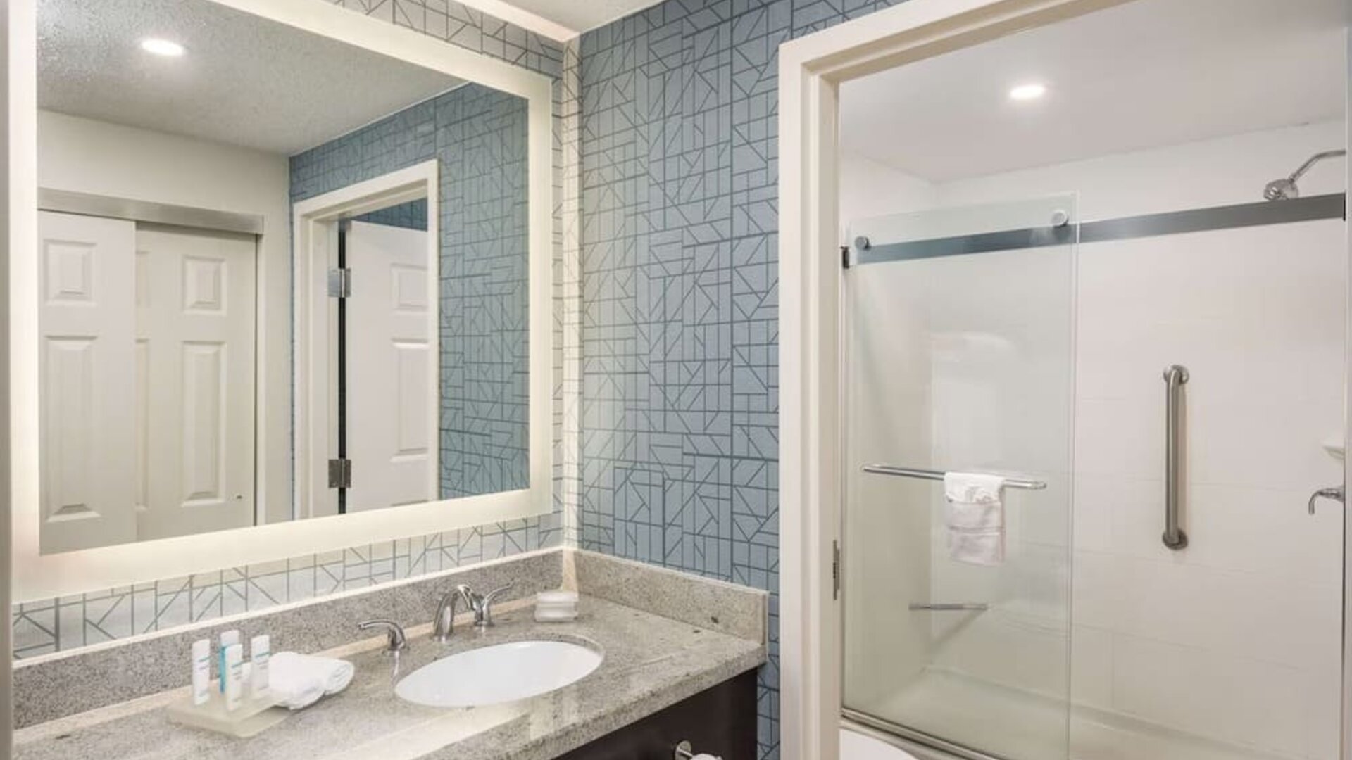 Guest bathroom with shower at Homewood Suites By Hilton Miami Airport-Blue Lagoon.