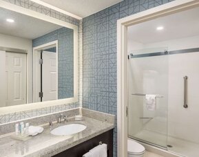 Guest bathroom with shower at Homewood Suites By Hilton Miami Airport-Blue Lagoon.