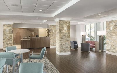 Lobby and coworking lounge at Homewood Suites By Hilton Miami Airport-Blue Lagoon.