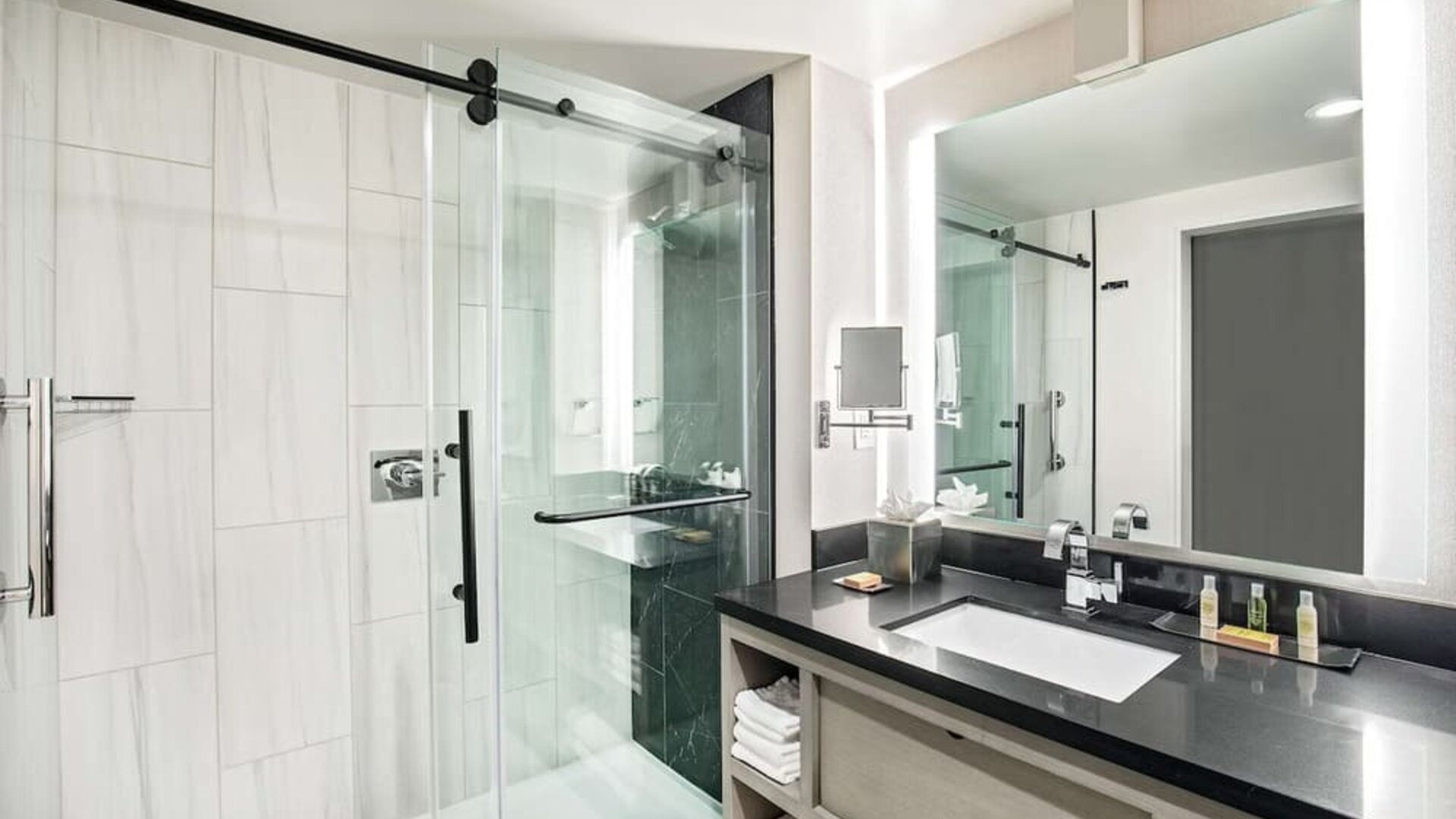 Private guest bathroom with shower and free toiletries at DoubleTree By Hilton Washington DC North/Gaithersburg.