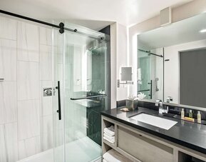 Private guest bathroom with shower and free toiletries at DoubleTree By Hilton Washington DC North/Gaithersburg.
