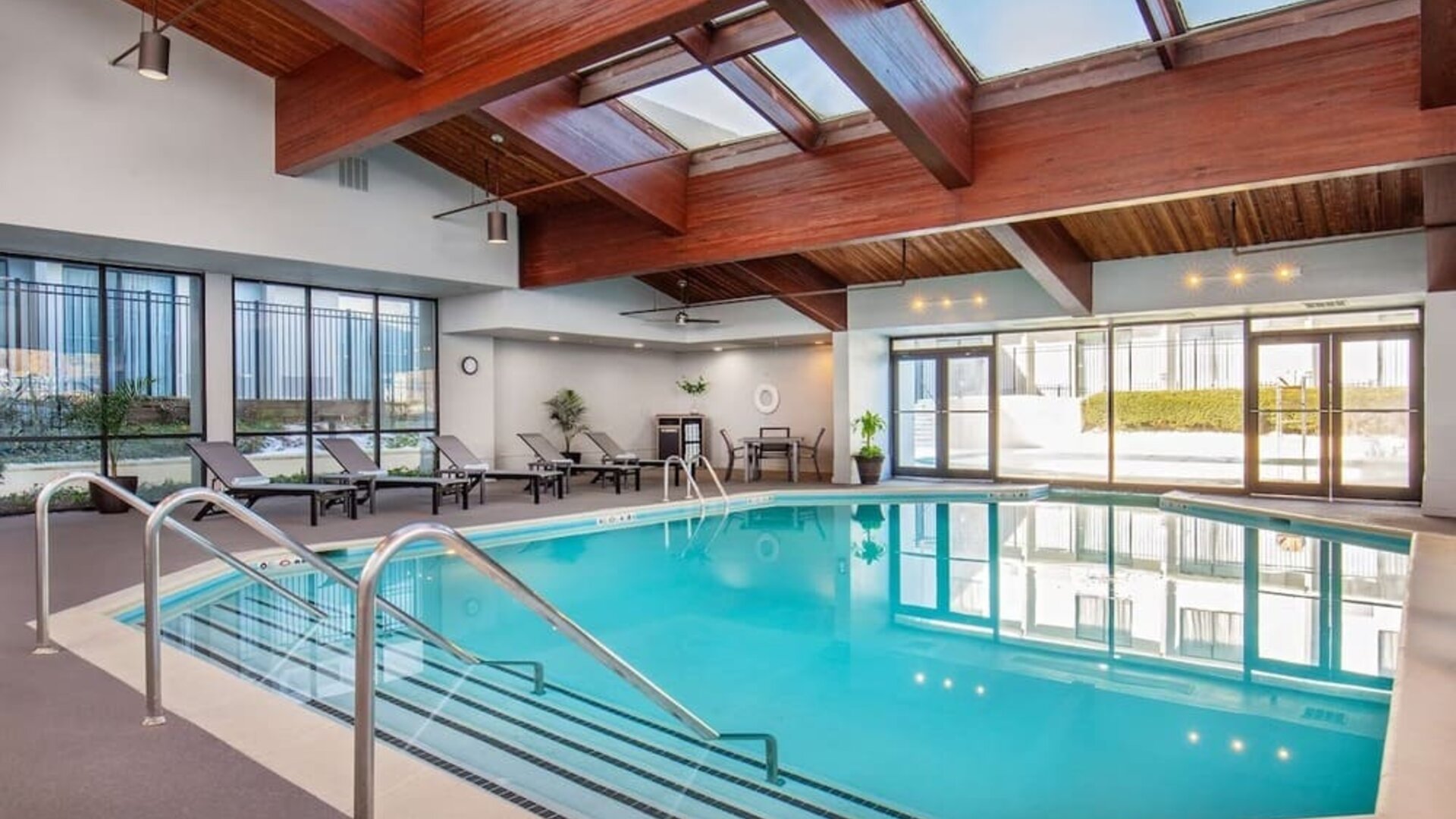 Relaxing indoor pool with lounge chairs at DoubleTree By Hilton Washington DC North/Gaithersburg.