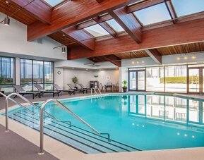 Relaxing indoor pool with lounge chairs at DoubleTree By Hilton Washington DC North/Gaithersburg.