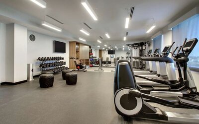 Well equipped fitness center at The Rose Hotel Chicago O’Hare, Tapestry Collection By Hilton.