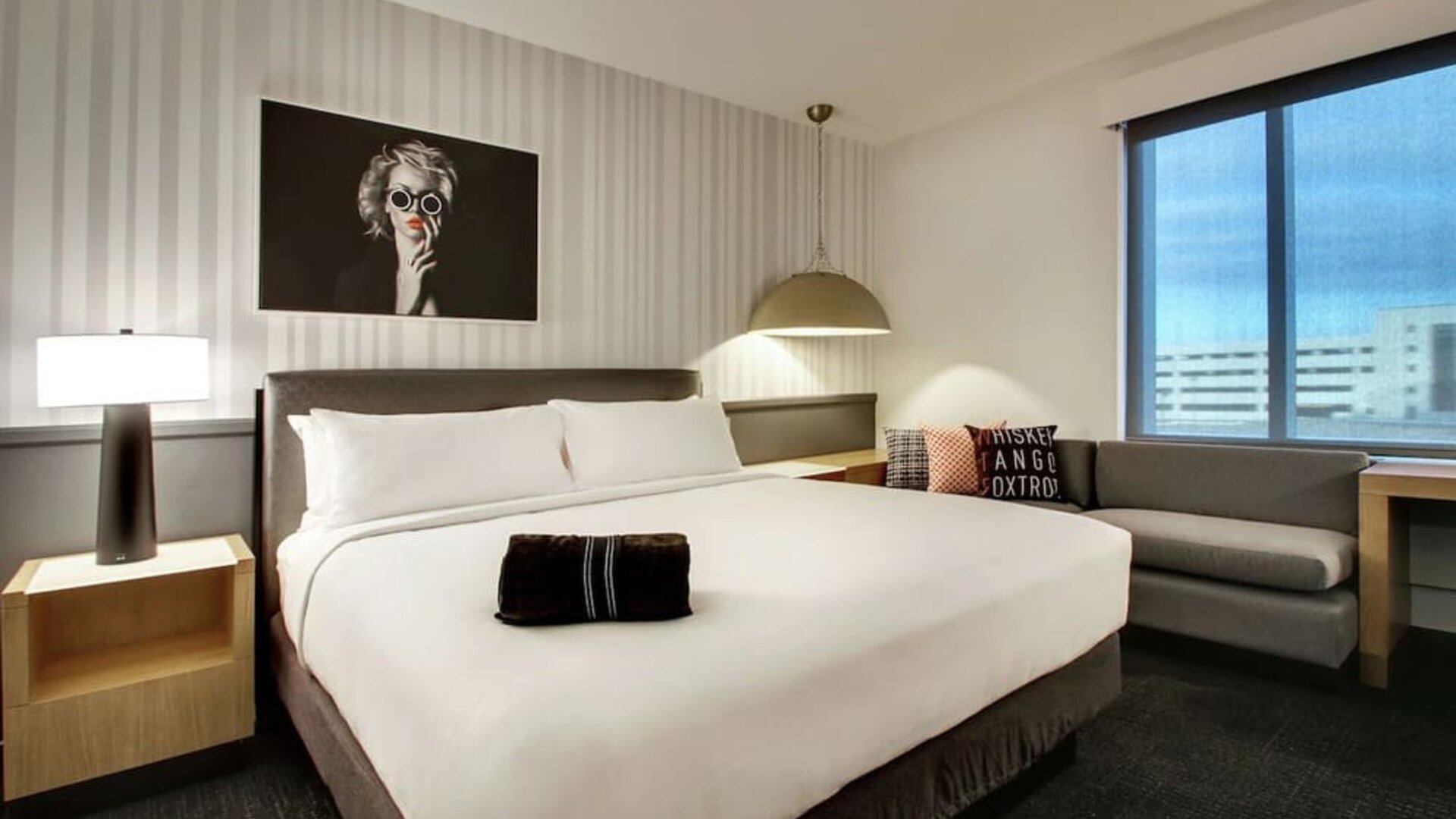 Day use room with sofa and work desk at The Rose Hotel Chicago O’Hare, Tapestry Collection By Hilton.