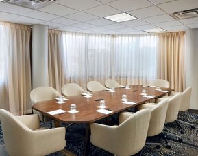 Professional meeting room with comfortable seating at Embassy Suites By Hilton West Palm Beach Central.