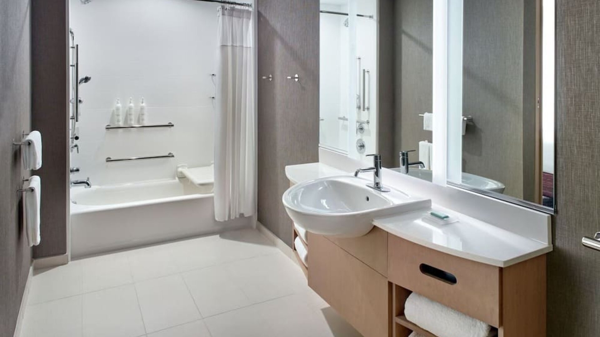 Private guest bathroom with combined shower and tub at 	SpringHill Suites Atlanta Northwest.
