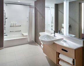 Private guest bathroom with combined shower and tub at 	SpringHill Suites Atlanta Northwest.