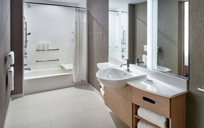 Private guest bathroom with combined shower and tub at 	SpringHill Suites Atlanta Northwest.