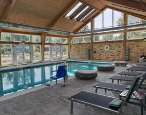 Pool loungers and indoor pool at Crowne Plaza Chicago SW.