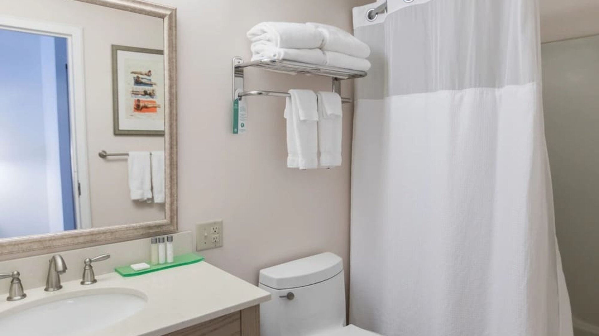 Private guest bathroom with shower and free toiletries at Sea Crest Beach Hotel.