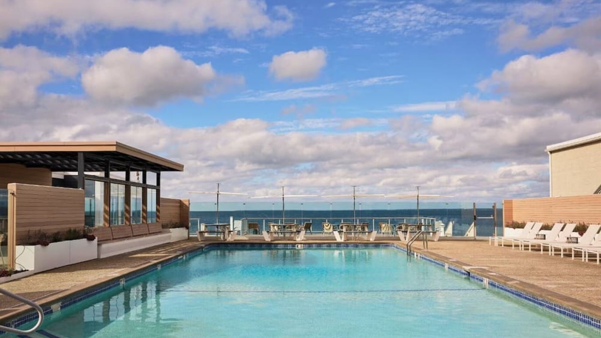 Outdoor pool with lounge chairs at Sea Crest Beach Hotel.