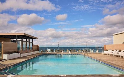 Outdoor pool with lounge chairs at Sea Crest Beach Hotel.