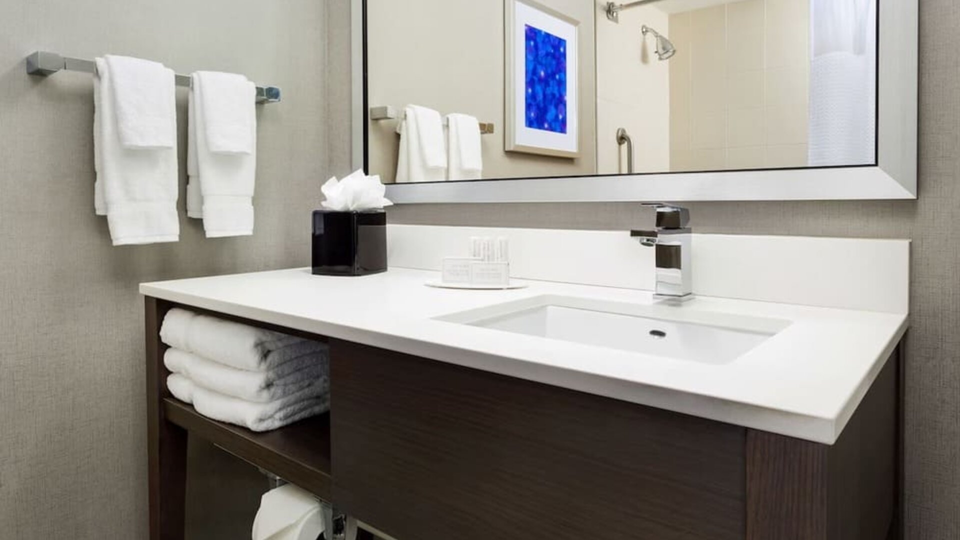 Private guest bathroom with shower and free toiletries at Courtyard Boston Cambridge.