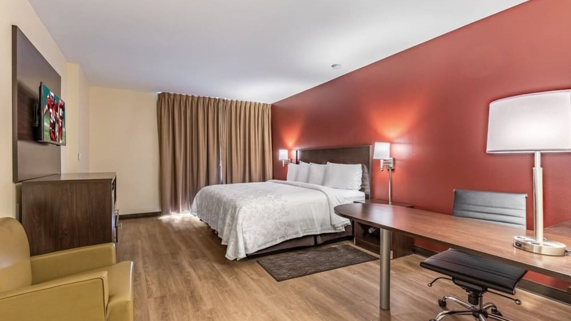 Spacious delux king bedroom with work desk at Red Roof PLUS+ & Suites Houston - IAH Airport SW.