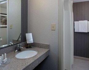 Private guest bathroom with shower and free toiletries at Sonesta Select Atlanta Norcross I-85.