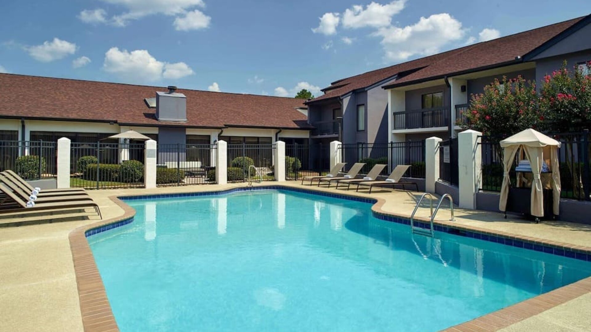Outdoor pool with lounge chairs at Sonesta Select Atlanta Norcross I-85.
